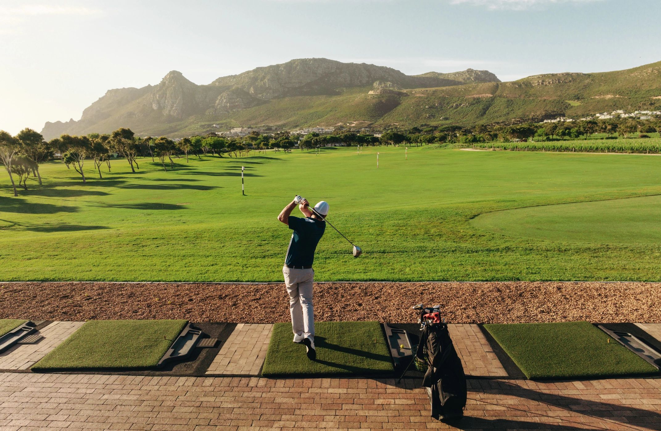 Golfer hitting a shot at a driving range